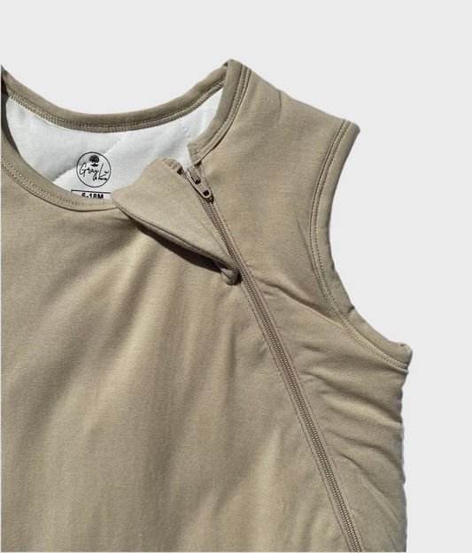 Beige sleep sack with two way zipper on a light gray background